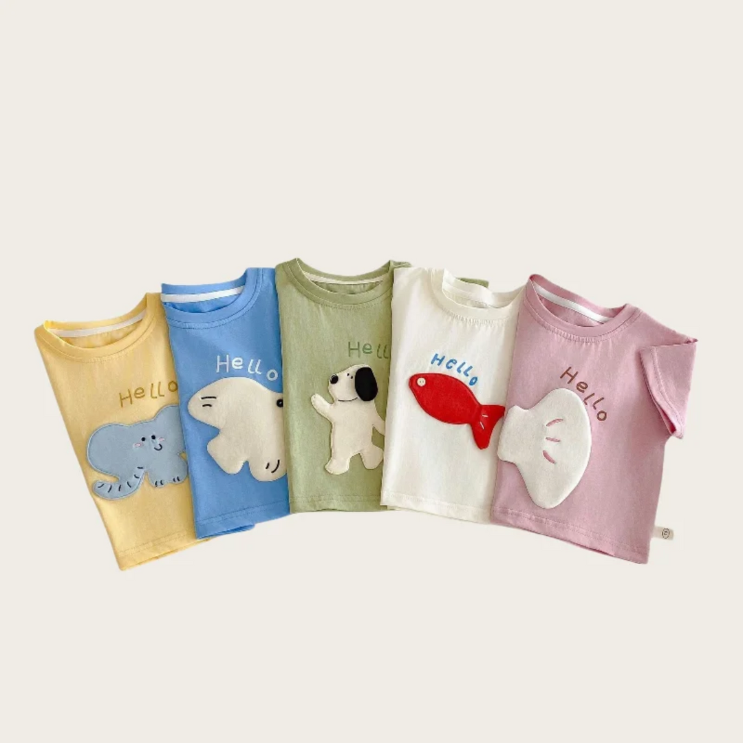 Five folded T-shirts showing cartoon patches and Hello lettering