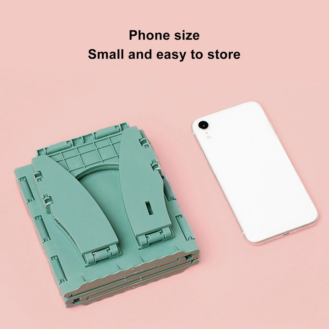 Folded green portable potty beside a smartphone for a size comparison