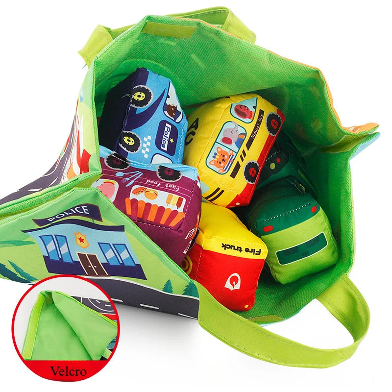 Road play mat folded into a green handled carry bag holding soft toy vehicles