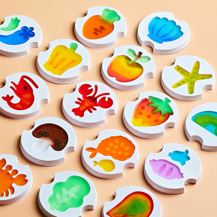 White craft molds filled with colorful fruit, vegetable, and sea-life shapes