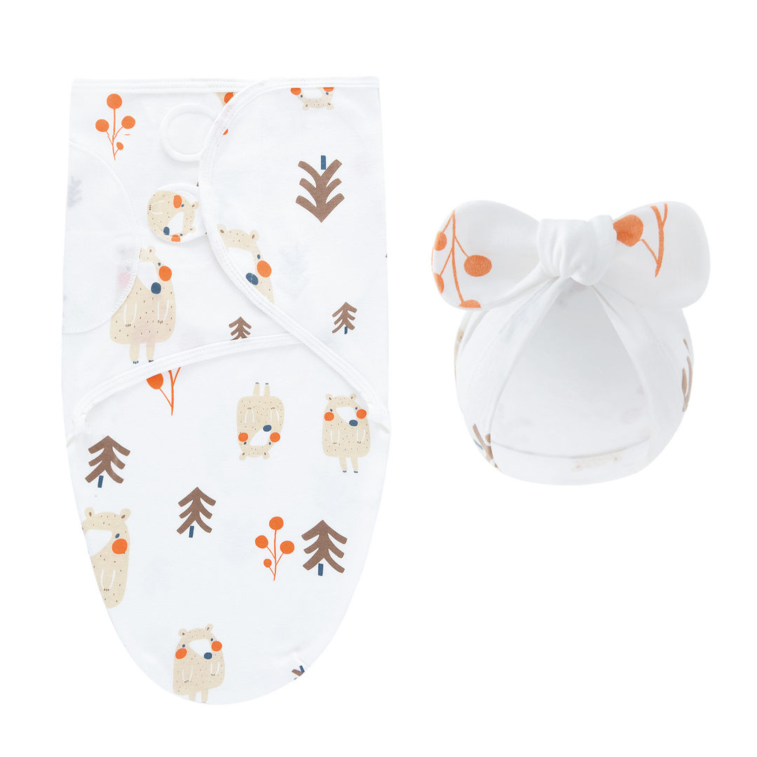 White swaddle blanket and matching bow hat with woodland animals and trees
