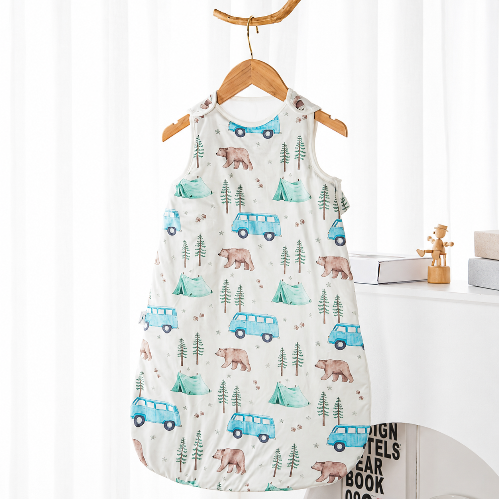 Baby sleep sack patterned with bears, pine trees, and blue vans