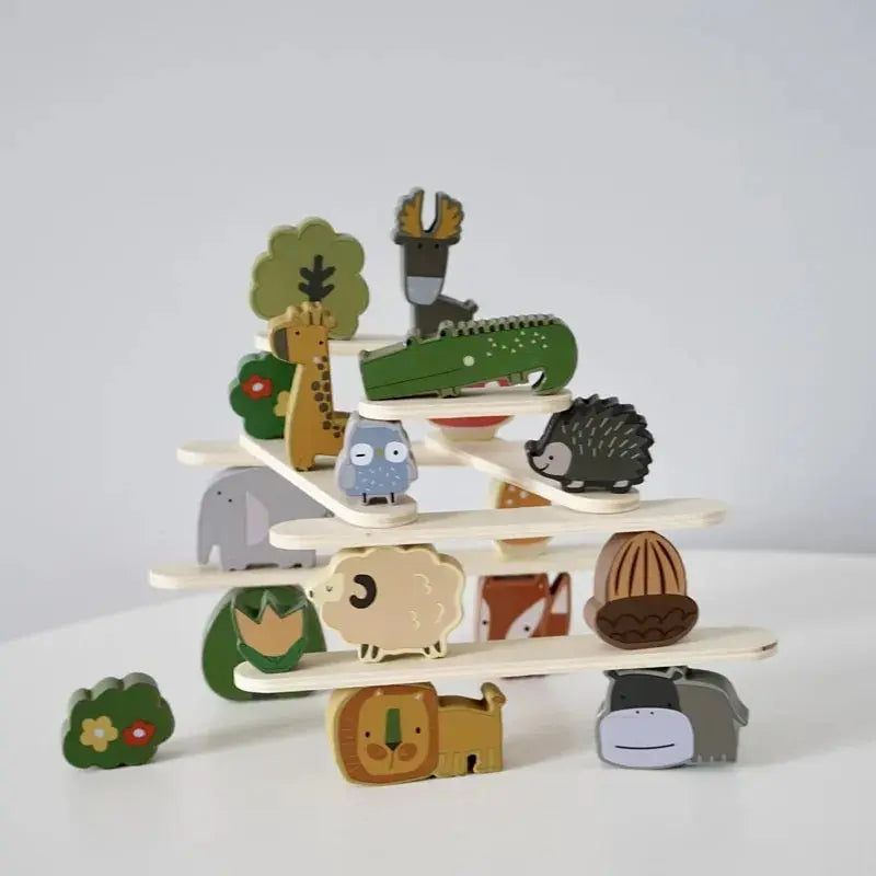 Wooden animal blocks balanced on layered sticks with a giraffe, crocodile, and hedgehog.