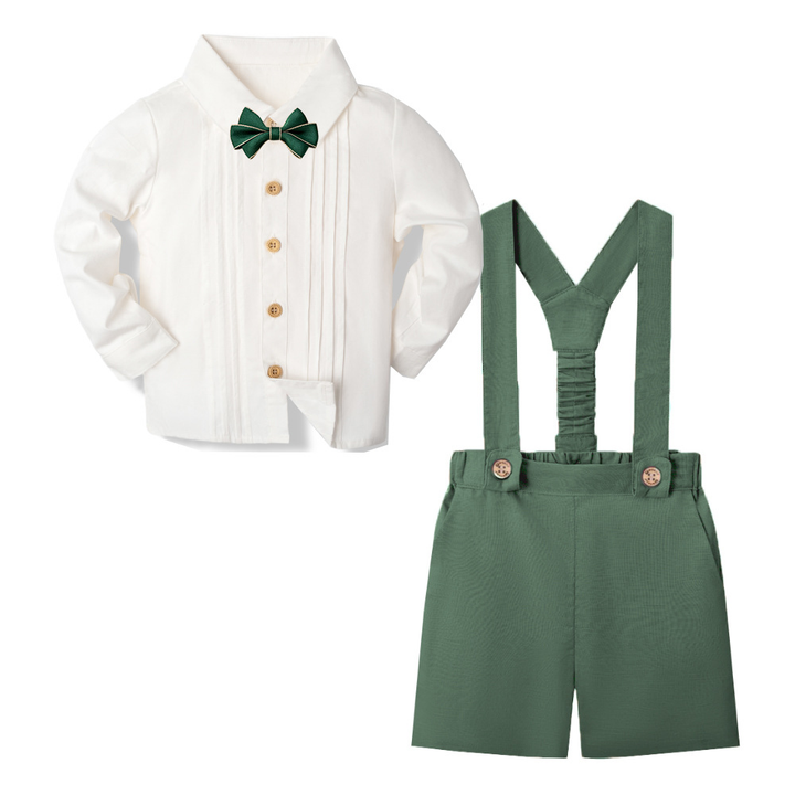 Forest green suspender shorts with a white long-sleeve shirt and green bow tie