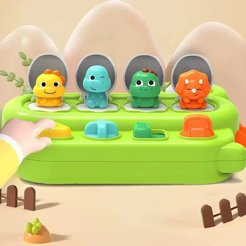 Green pop-up activity toy with four animal figures revealed above colorful controls