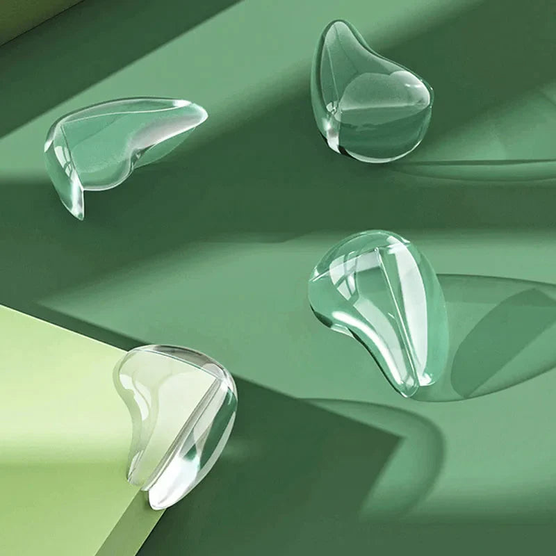 Four transparent corner covers arranged on a green surface