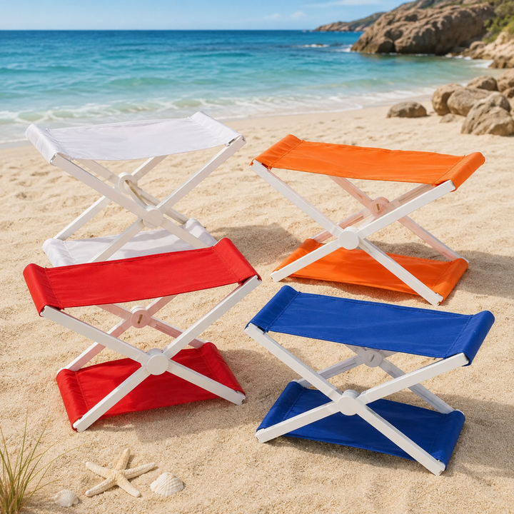 Blue, orange, red, and white folding headrests with cross-frames on a sandy beach