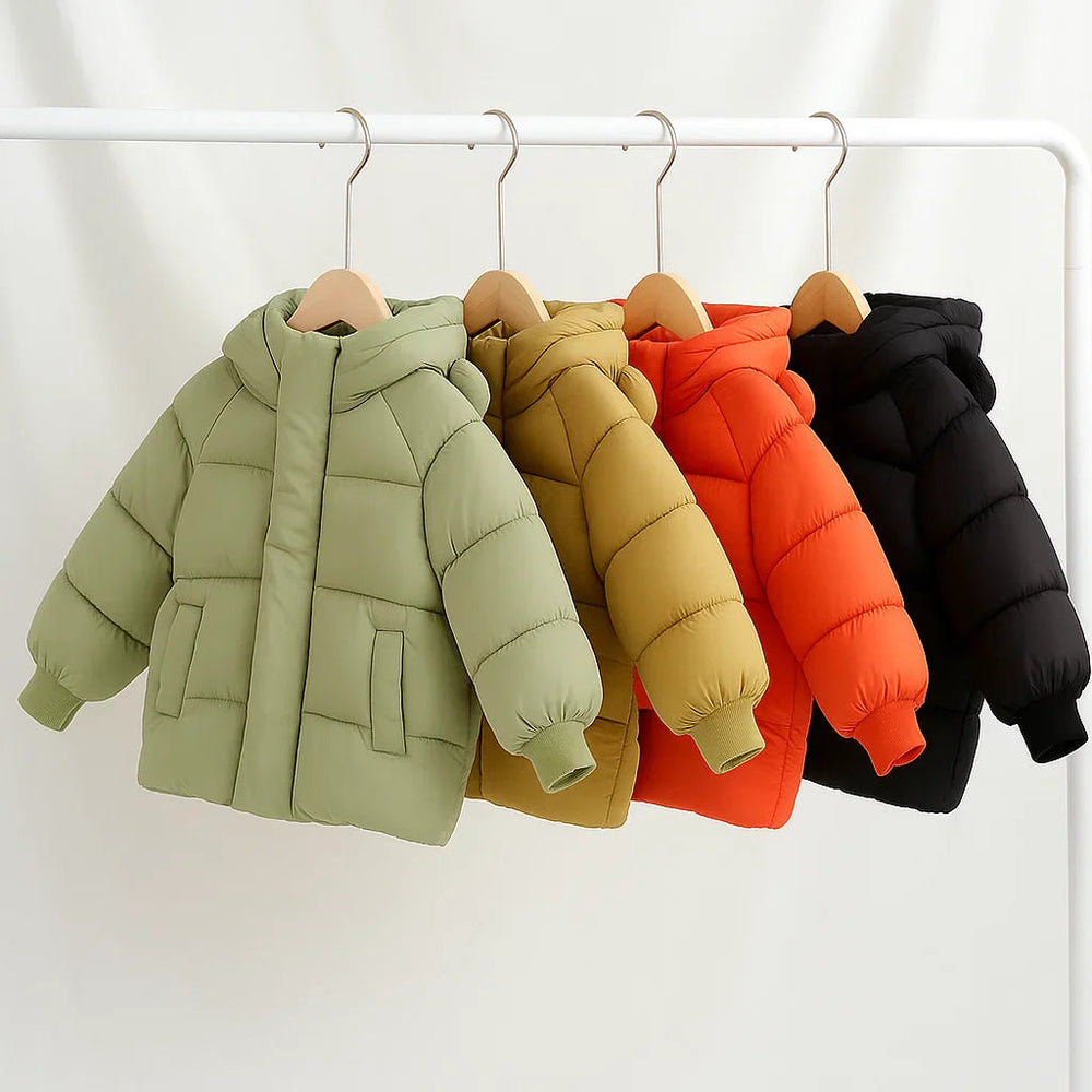 Green, brown, red, and black quilted children's coats hanging on a clothing rack