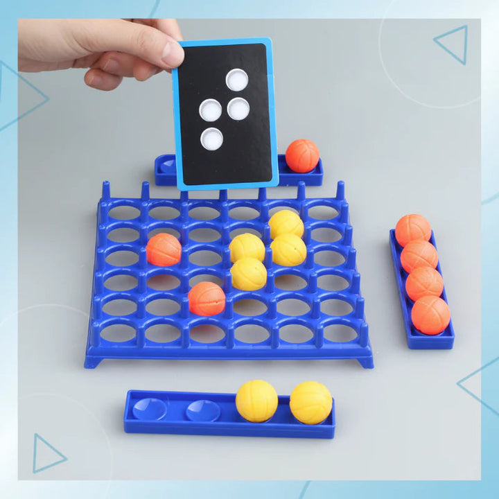 Four-dot challenge card held above the grid with yellow and orange balls