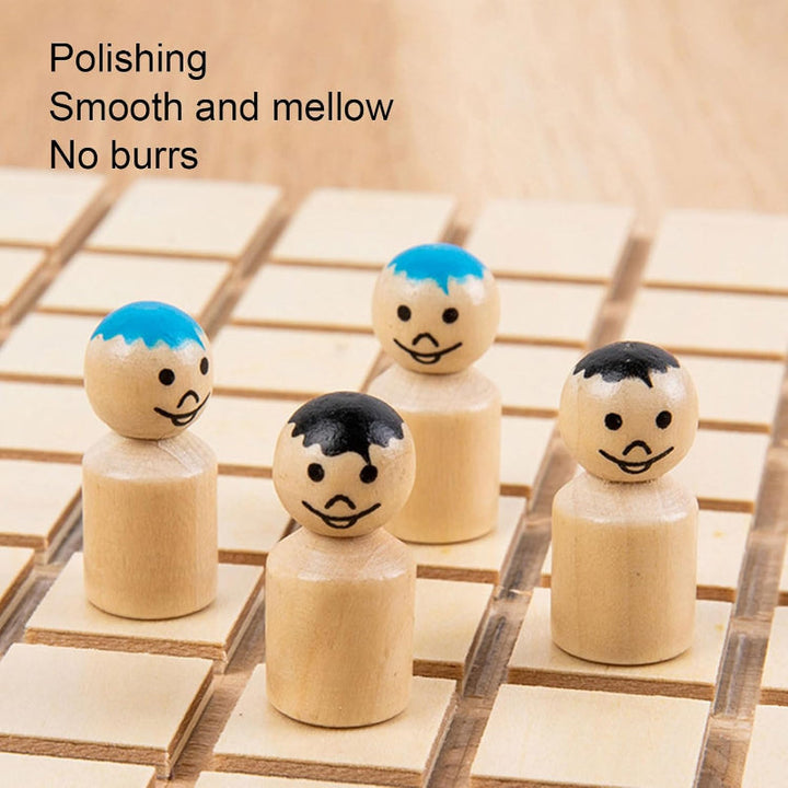Close-up of four wooden pawns with painted faces and blue or black details