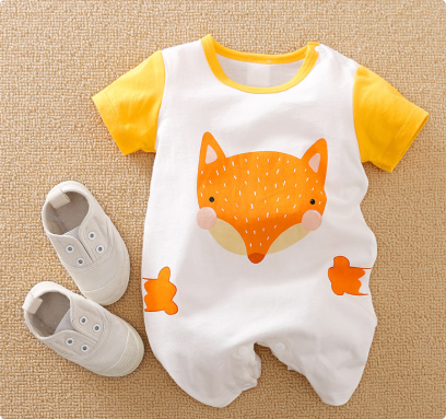 White fox-design baby romper with yellow sleeves, laid flat beside gray shoes