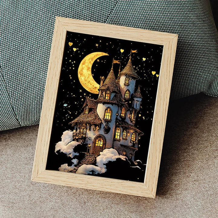 Moon-and-castle scratch artwork displayed in a wooden frame