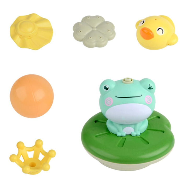 Frog bath fountain shown with a yellow crown, orange ball, and colorful toppers