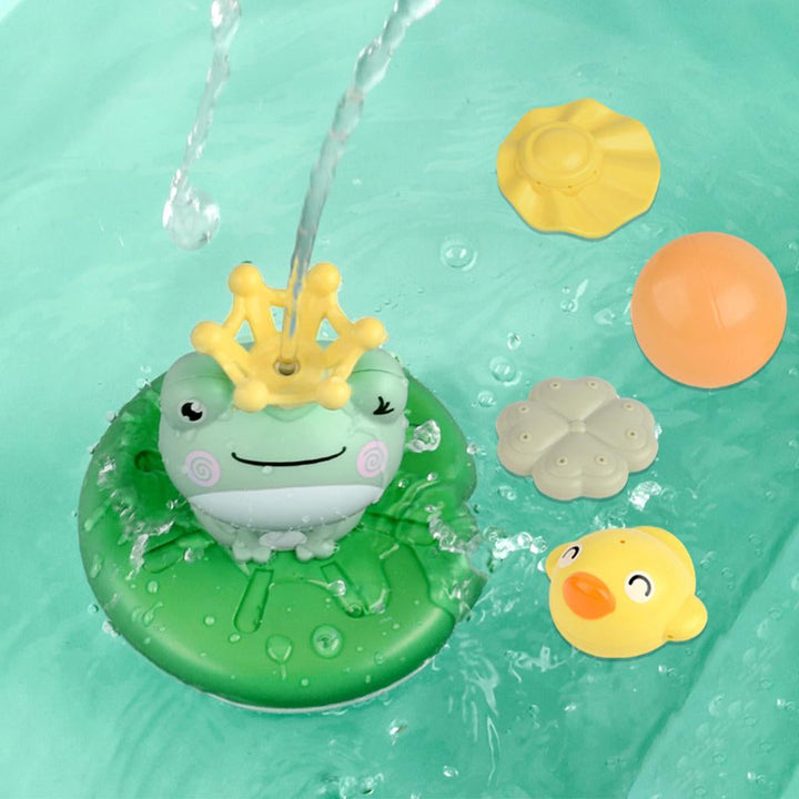 Overhead view of a frog bath fountain spraying water beside colorful toppers