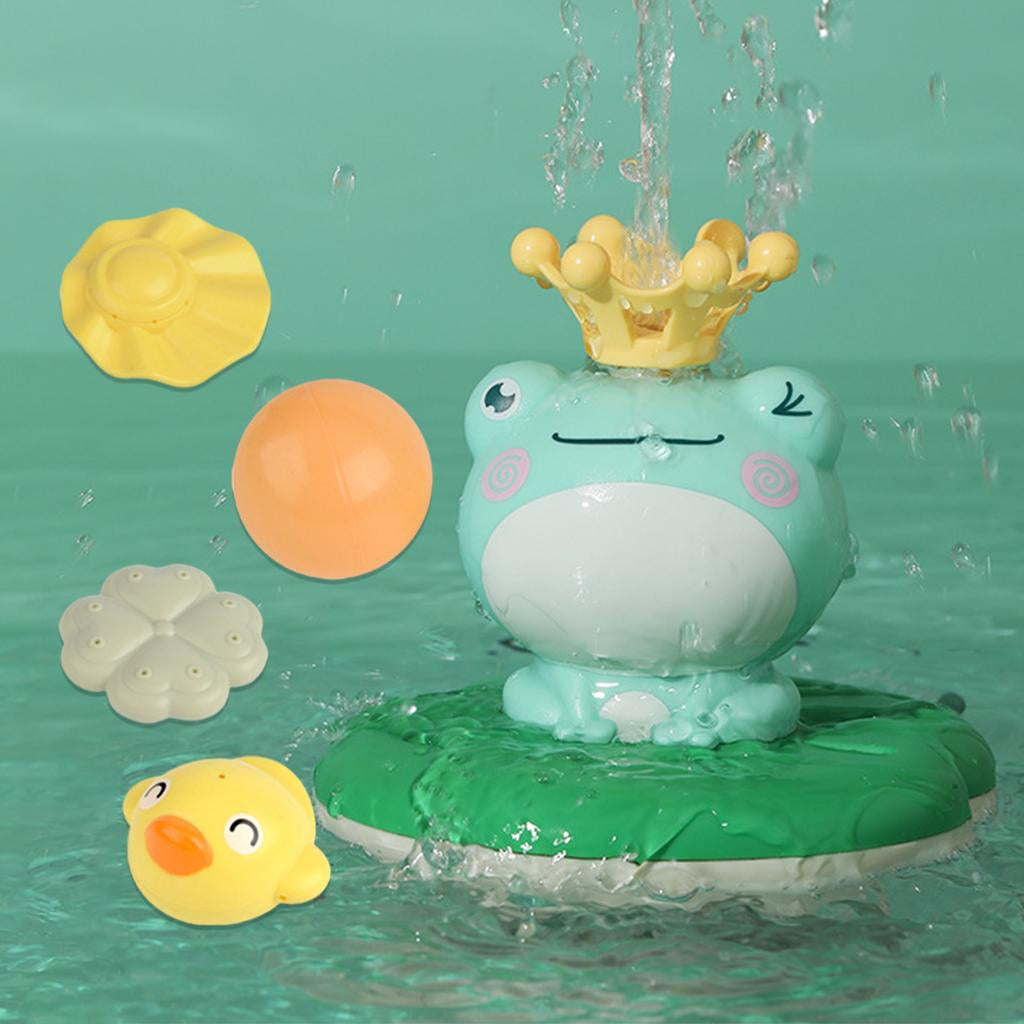 Water sprays from a crowned frog fountain on a green lily-pad base