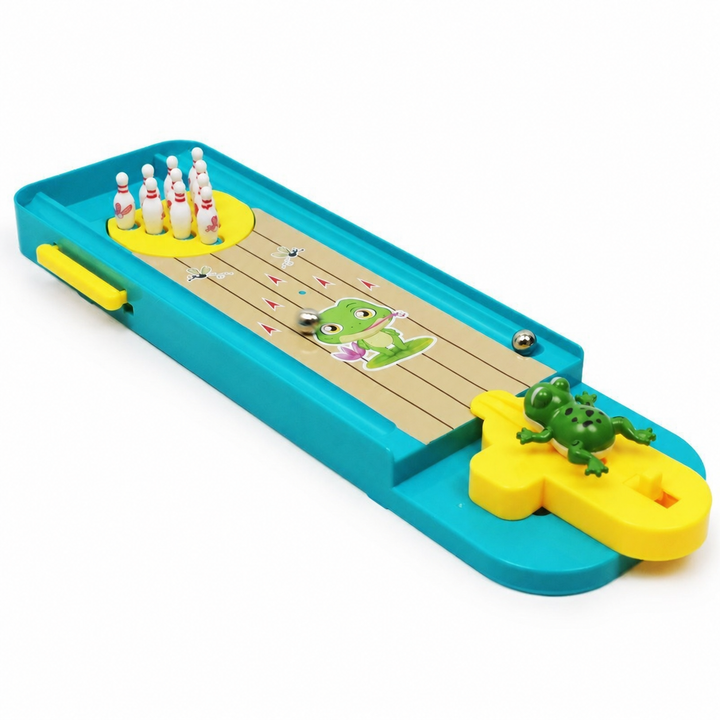 Angled view of the bowling lane with white pins, a metal ball, and a green frog launcher
