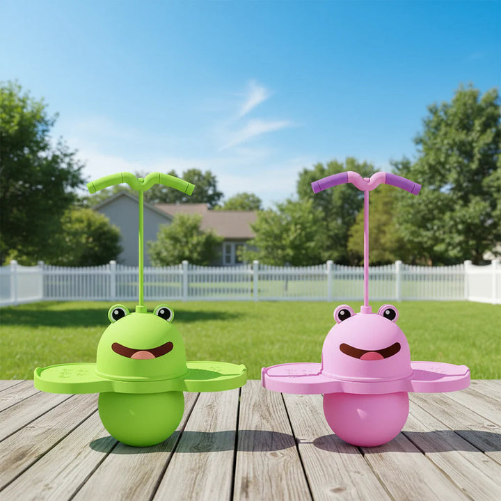 Green and pink frog pogo sticks standing on a wooden deck outdoors.