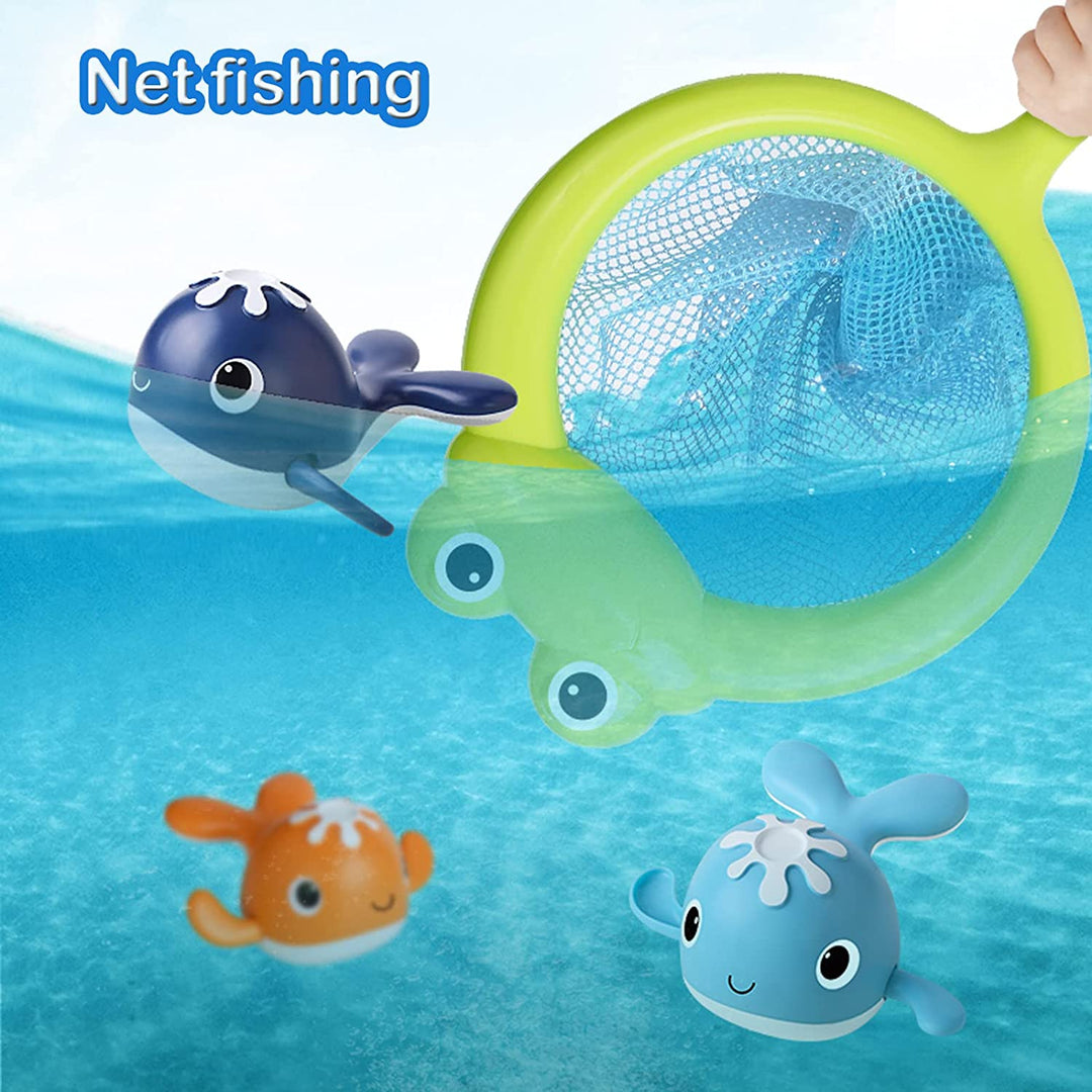Green frog-shaped fishing net beside floating navy, orange and light blue whale toys.