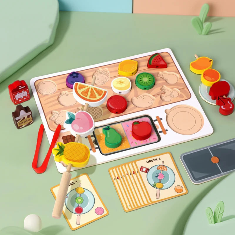 Fruit sorting set with a wooden puzzle board, threaded fruit skewers, red tongs and order cards