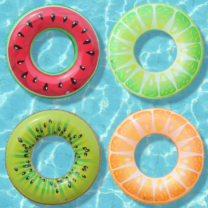 Watermelon, lime, kiwi, and orange swim rings floating in a pool.