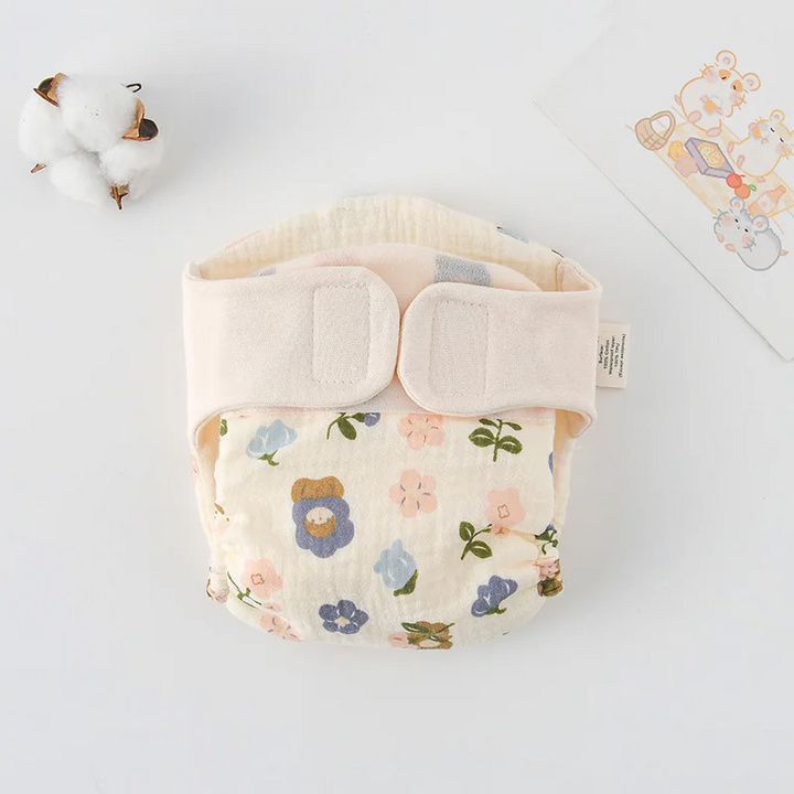 Floral garden-print cloth diaper with a cream hook-and-loop waistband