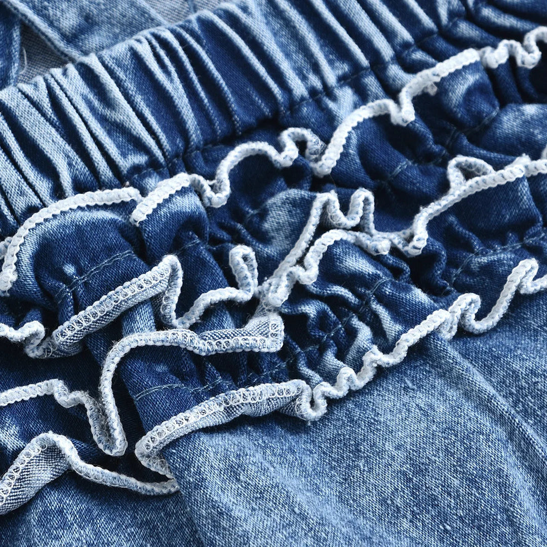Detail of the gathered back waist and contrasting trim on the denim romper&