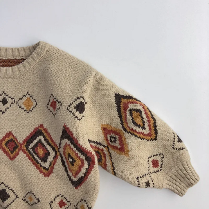Diamond pattern across the front and long sleeve of the beige kids&