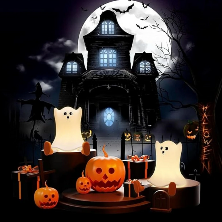Glowing ghost night lights among pumpkins in a haunted-house Halloween scene