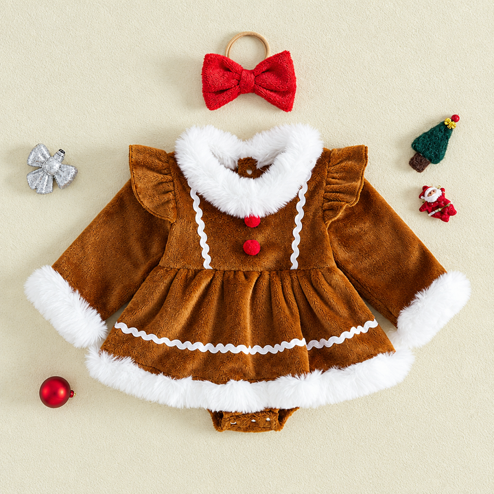 Brown gingerbread-style baby romper with white trim and a red bow headband laid flat.
