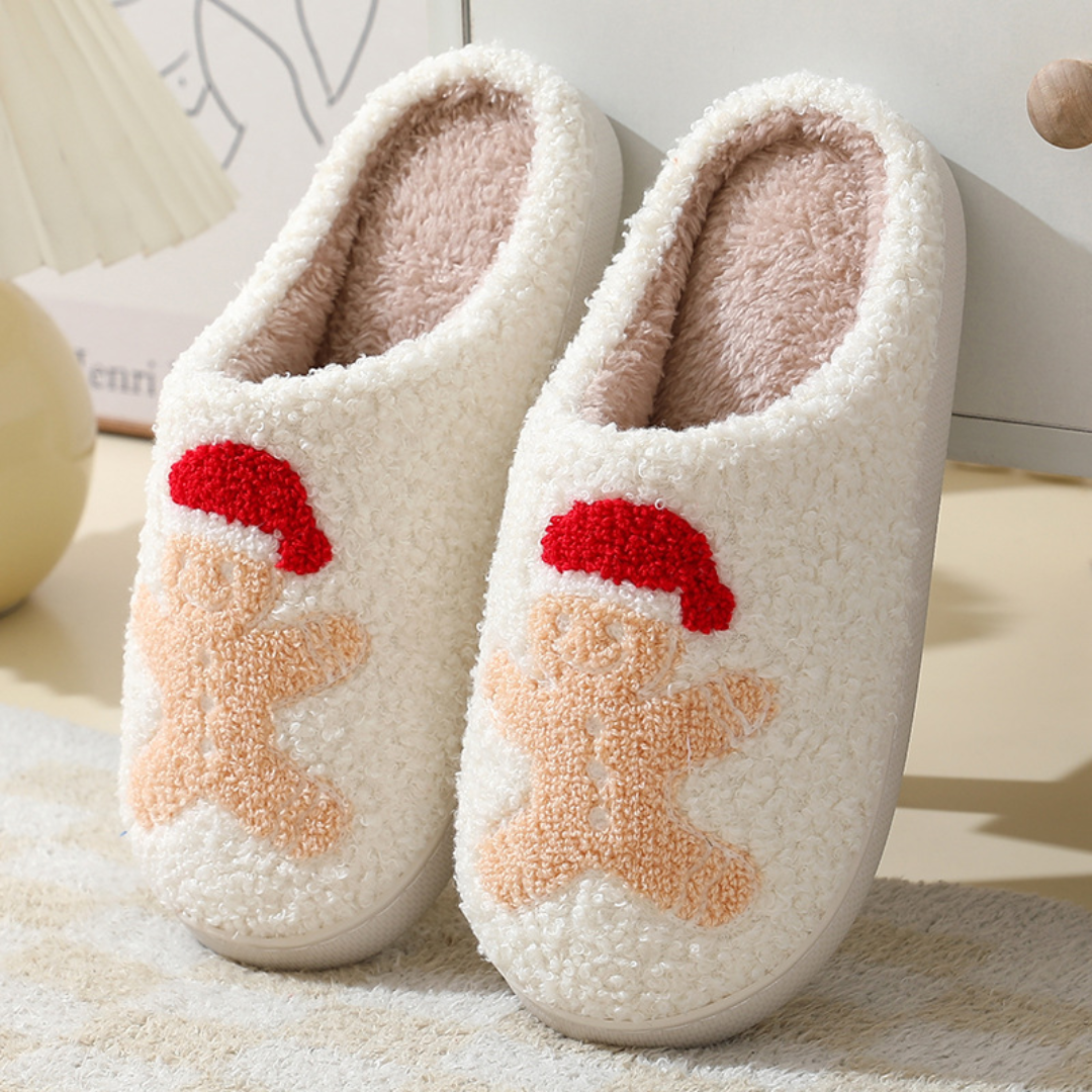 Cream slippers with light brown gingerbread characters wearing red hats.