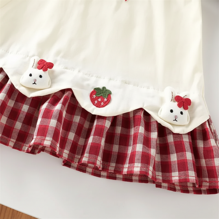 Scalloped hem with bunny and strawberry accents above the red gingham skirt