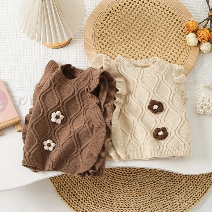 Brown and beige cotton knit vests displayed together with contrasting flower details