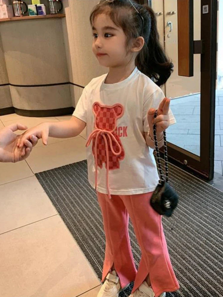 Girl wearing the pink-and-white summer set with split hems on the pants