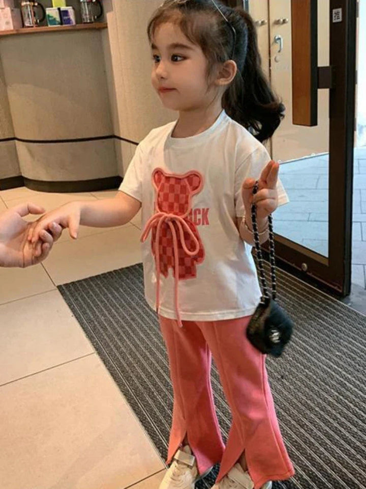 Girl wearing the pink-and-white summer set with split hems on the pants