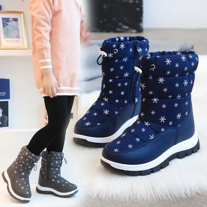 Blue snowflake snow boots with a smaller view of a child wearing dark boots
