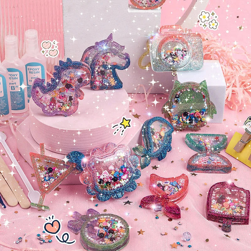 Colorful glitter-filled shaker keychains displayed with resin bottles and mixing sticks on a pink table