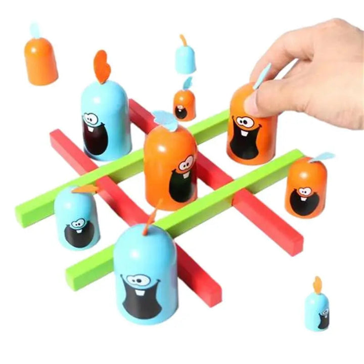 A hand places an orange piece among blue and orange pieces on a red and green tic-tac-toe grid.