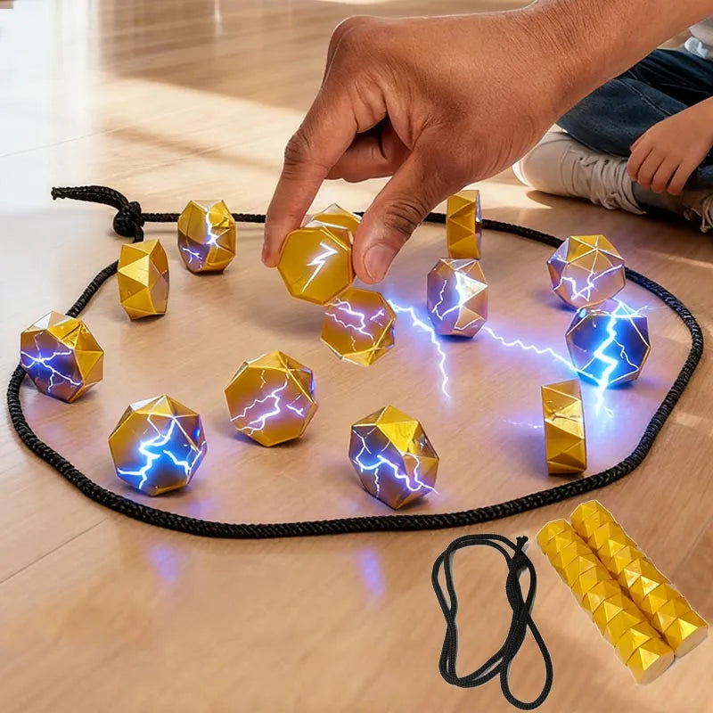 Hand placing a gold magnetic stone inside a black cord loop on a table