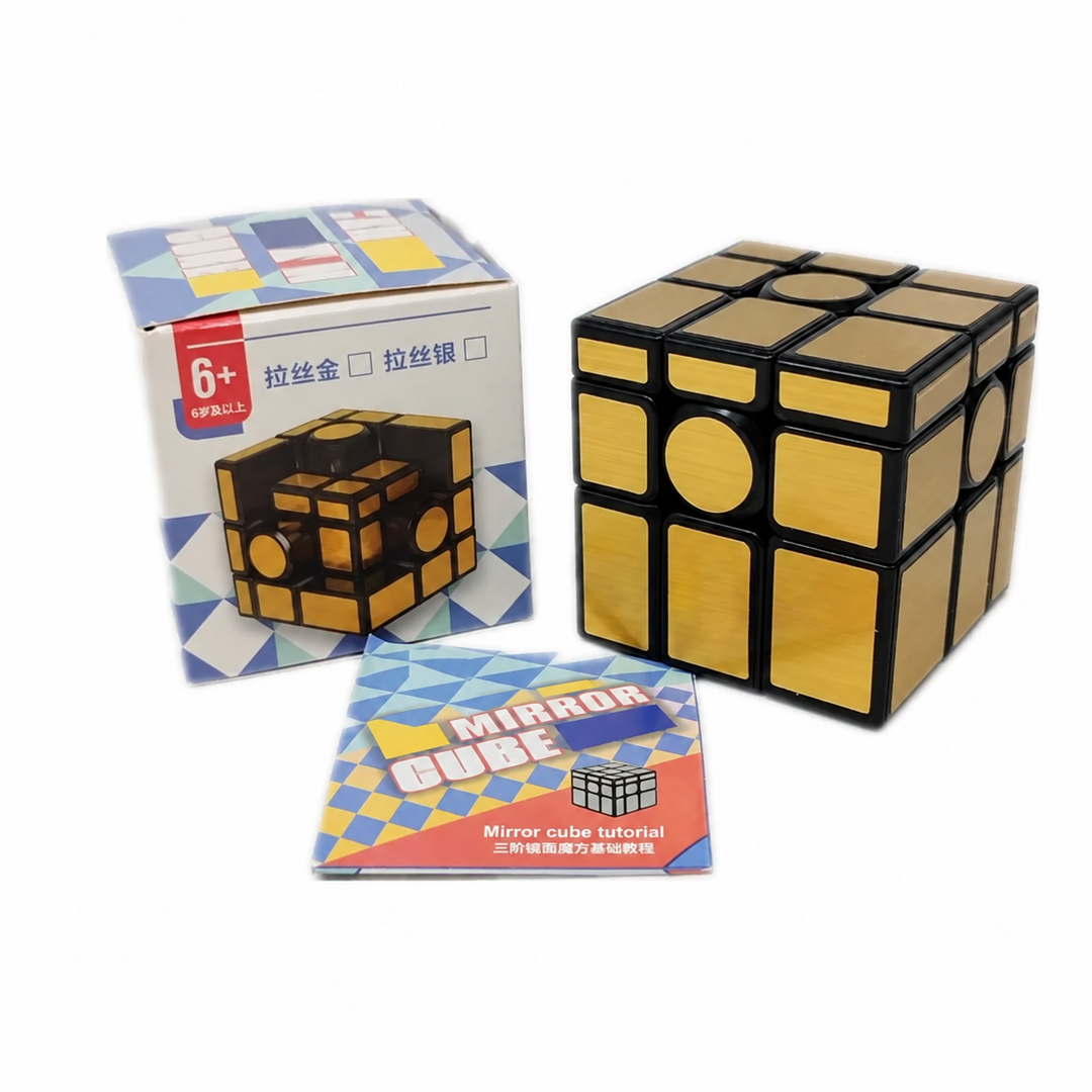Gold-tone mirror cube puzzle beside its box and instruction leaflet
