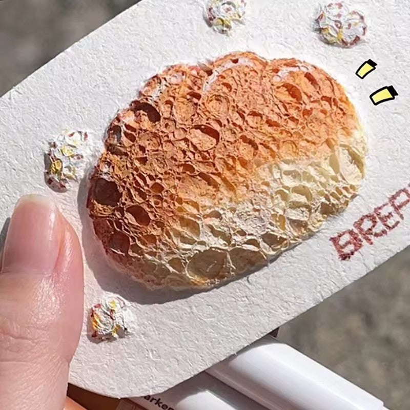 Close-up of golden-brown bread artwork with a raised, porous texture