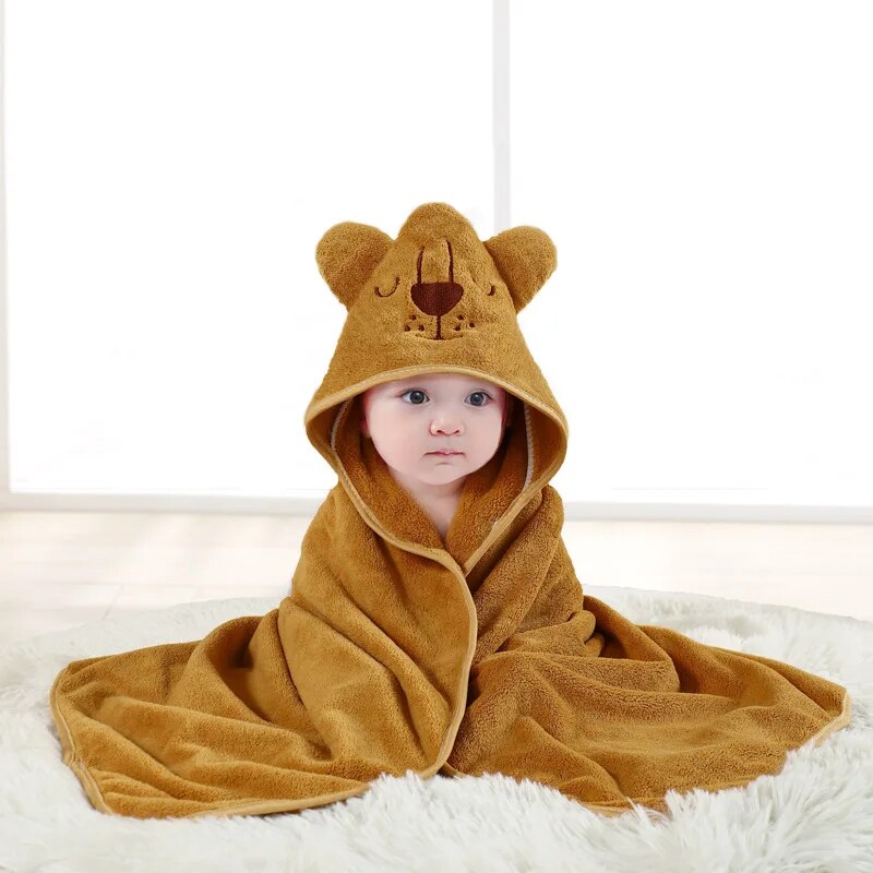 Child wrapped in a golden yellow lion hooded bath towel
