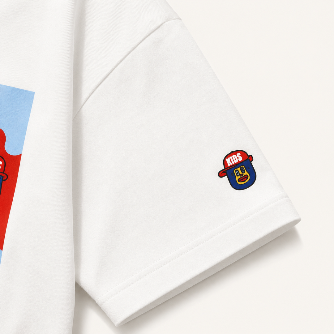 Close-up of the white T-shirt sleeve with a small colorful character print