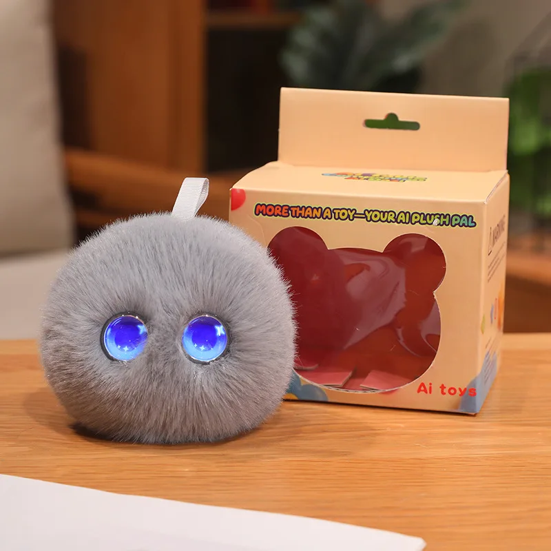 Gray AI plush toy with blue eyes displayed next to its retail box
