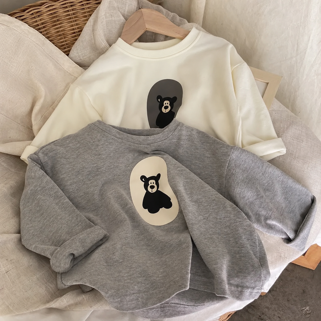 Front view of gray and white cotton sweaters with contrasting bear graphics