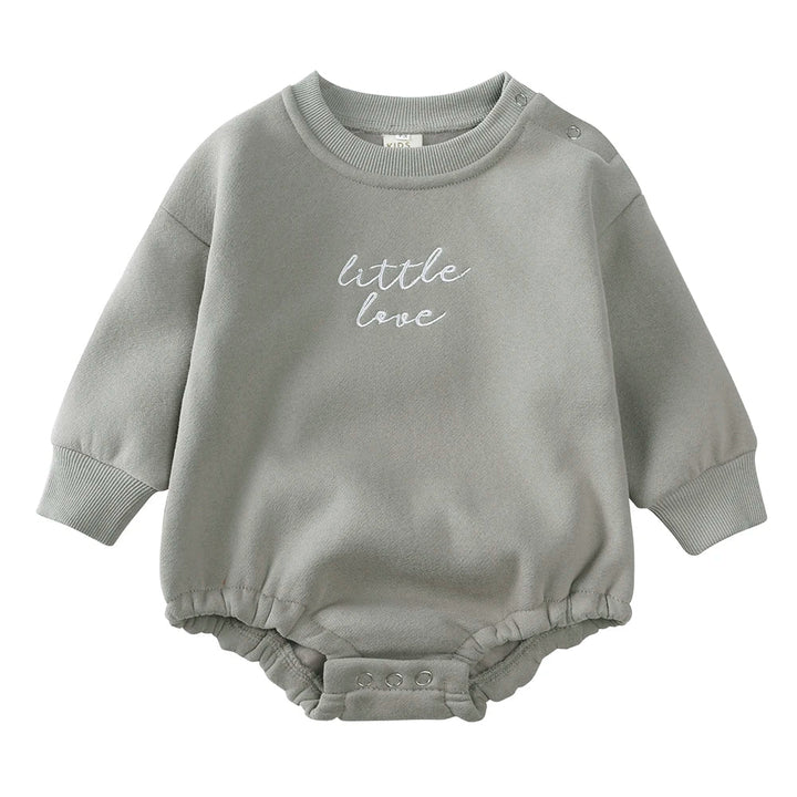 Gray cotton baby romper with white chest embroidery, long sleeves, and snap closures