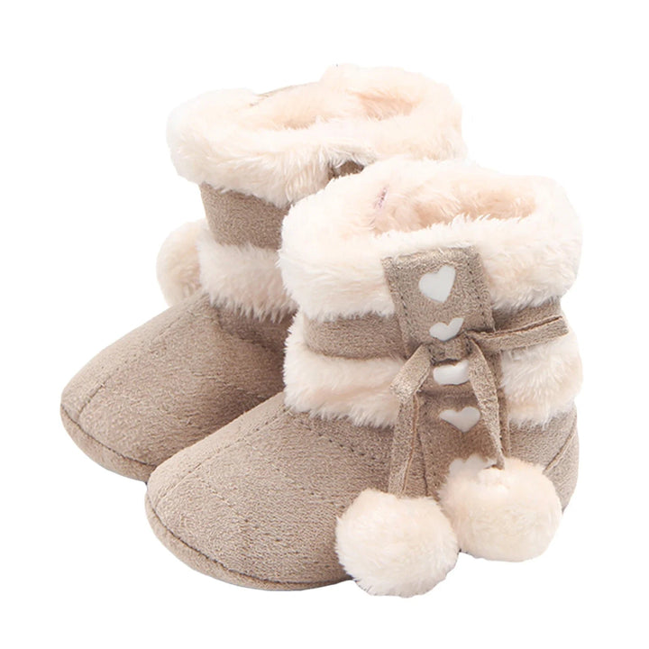 Gray baby snow boots with fluffy cream trim, heart details, and pom-poms