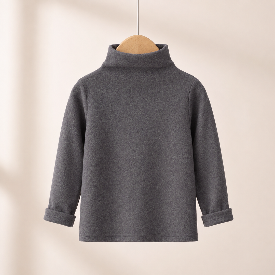 Gray baby sweater on a wooden hanger, showing its high neckline and turned-up cuffs.