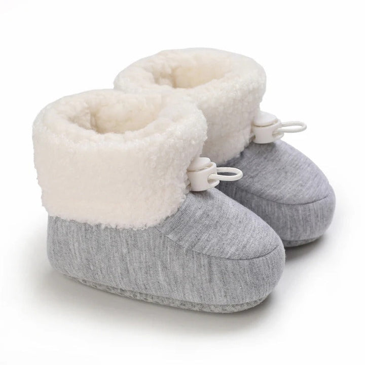 Gray baby winter boots with a heathered finish, fluffy white cuffs, and white toggles