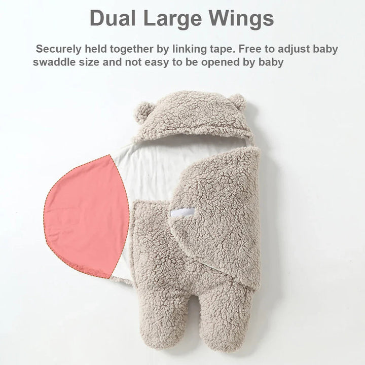 Gray baby wrap with one wing opened to show the lining and overlapping two-wing closure.