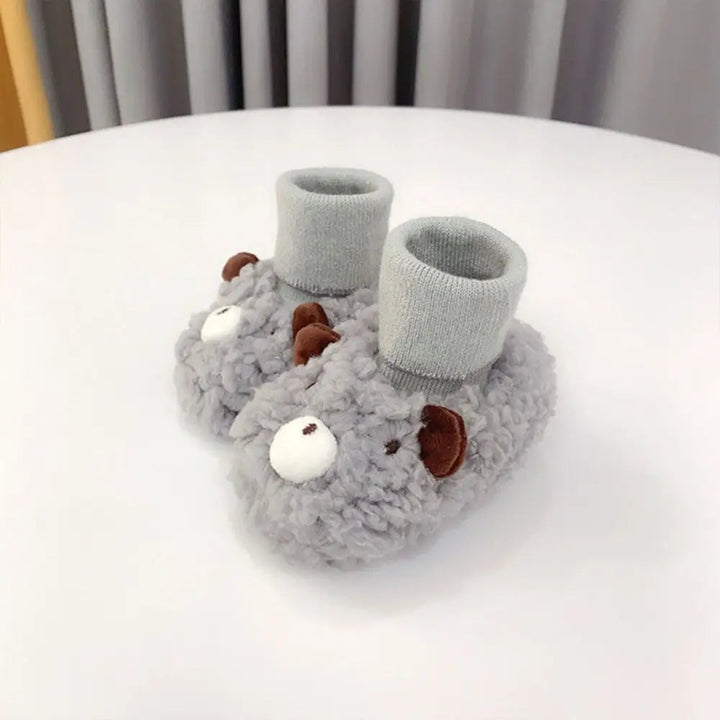 Gray bear baby slippers with brown ears, white muzzles, and matching ribbed cuffs